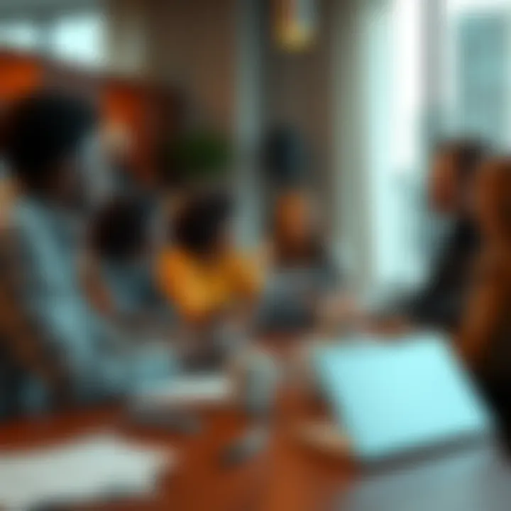 A group of diverse people engaged in a lively conversation around a table with laptops and notepads.