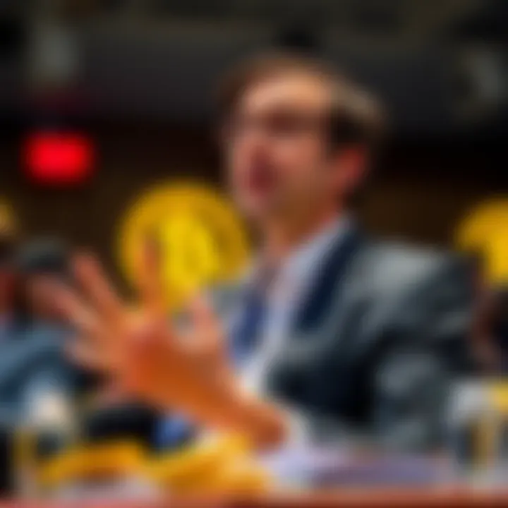 A Harvard economist gestures while talking about Bitcoin's future value during a panel discussion.