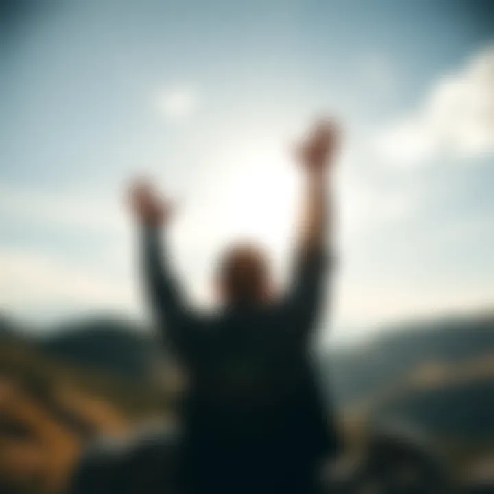 Symbol of Freedom A person raising their hands in the air, standing on a hilltop against a bright sky, symbolizing freedom and liberty in modern society.